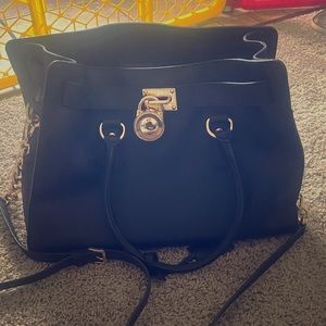 Black Mk tote with long strap and elbow straps.